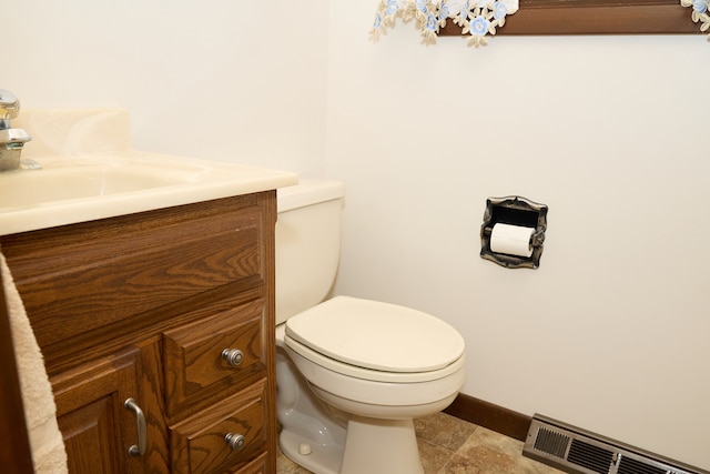 half bath featuring visible vents, toilet, vanity, baseboards, and tile patterned floors