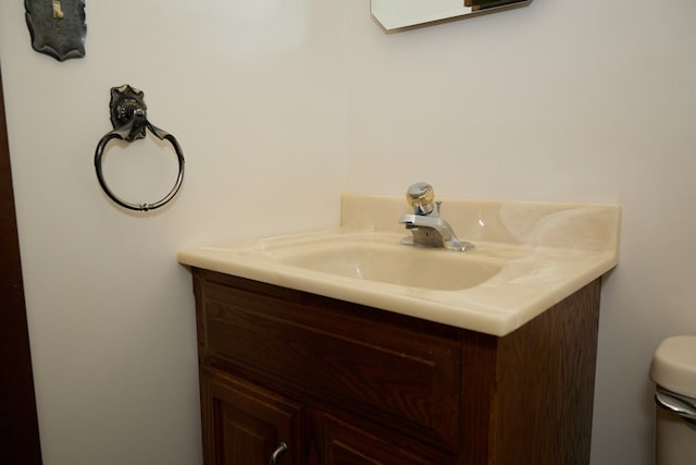 bathroom featuring toilet and vanity