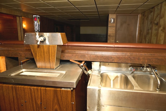 interior space featuring a sink and a drop ceiling