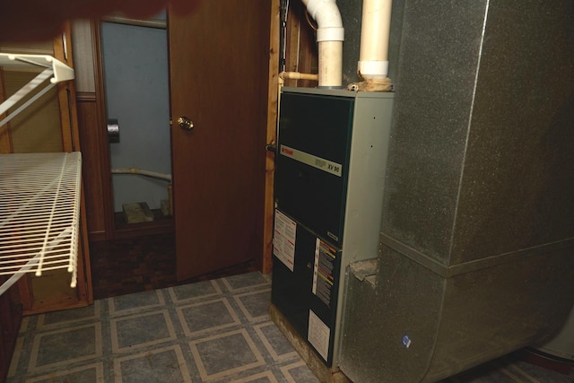 utility room featuring heating unit