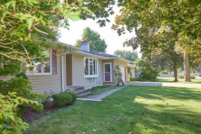 single story home featuring a garage, driveway, a chimney, and a front lawn