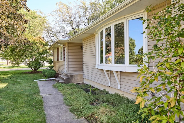 view of side of home featuring a lawn