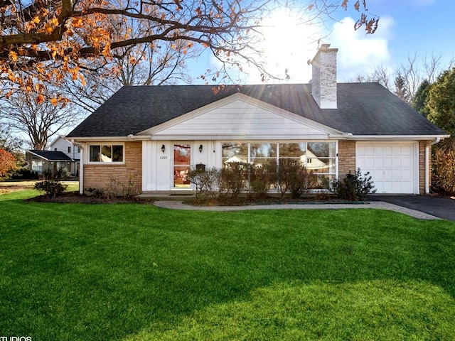 view of front of home featuring a garage and a front lawn