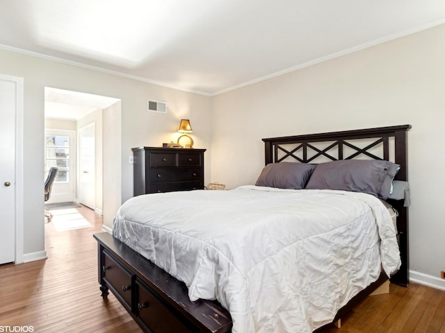 bedroom featuring hardwood / wood-style floors and ornamental molding