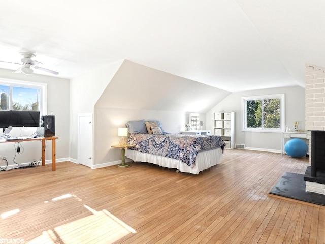 bedroom with hardwood / wood-style flooring, ceiling fan, and lofted ceiling