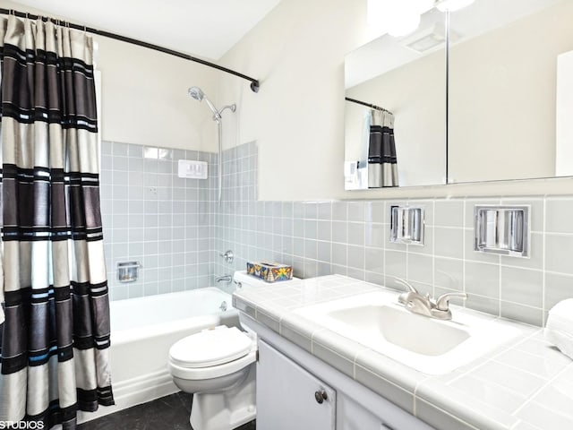 full bathroom featuring shower / bath combo with shower curtain, vanity, tile walls, and toilet