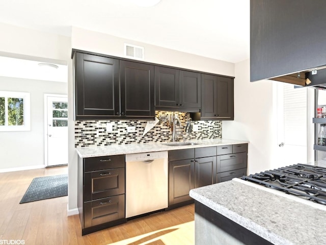 kitchen with backsplash, sink, light hardwood / wood-style flooring, appliances with stainless steel finishes, and dark brown cabinets