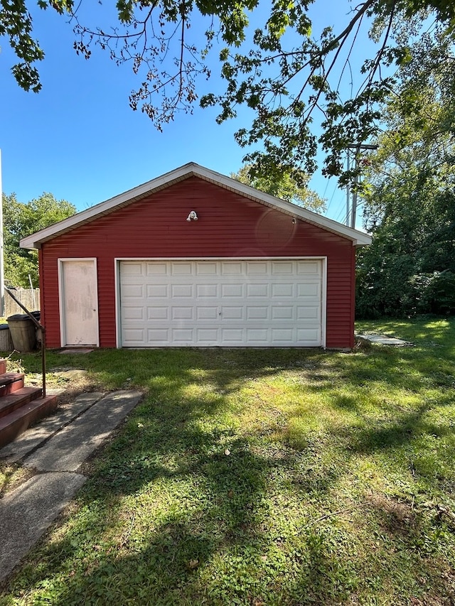 garage featuring a lawn