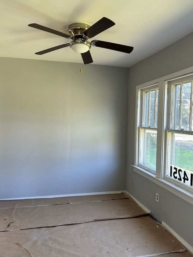 empty room with concrete flooring and ceiling fan