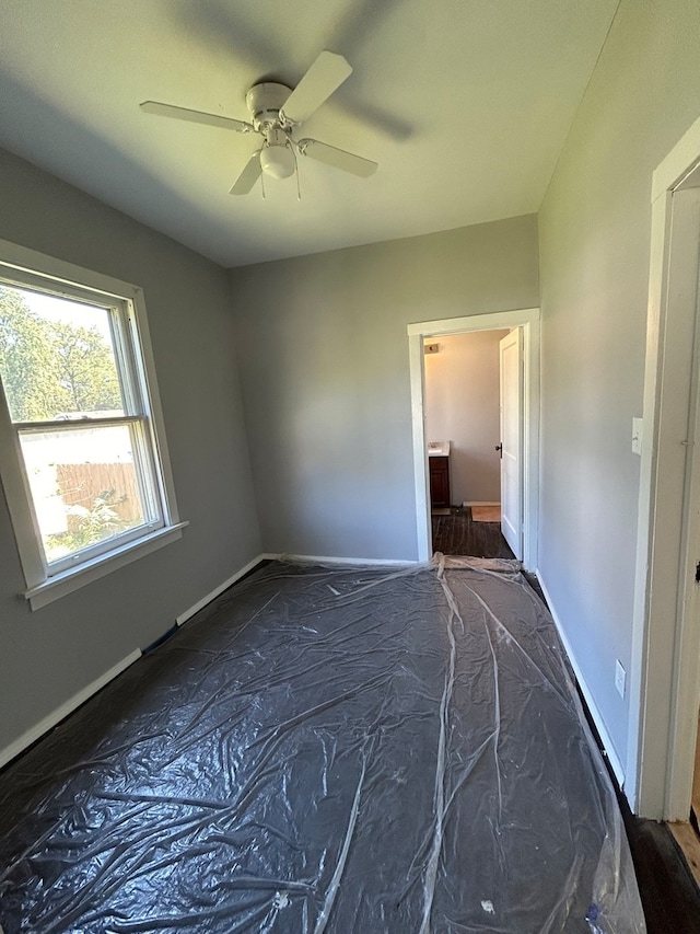 unfurnished bedroom featuring ceiling fan and hardwood / wood-style flooring