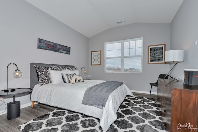 bedroom featuring vaulted ceiling and dark hardwood / wood-style flooring