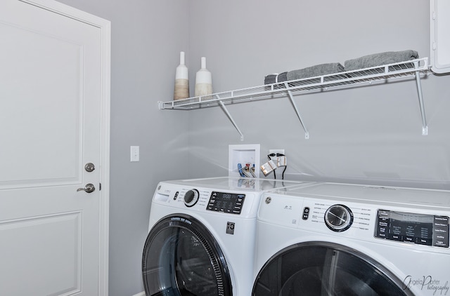 washroom with washing machine and clothes dryer