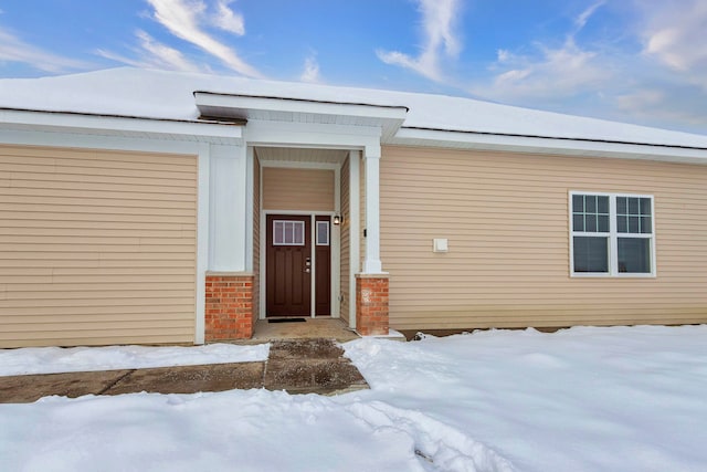 view of snow covered property entrance