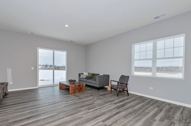 living area featuring a water view and hardwood / wood-style floors