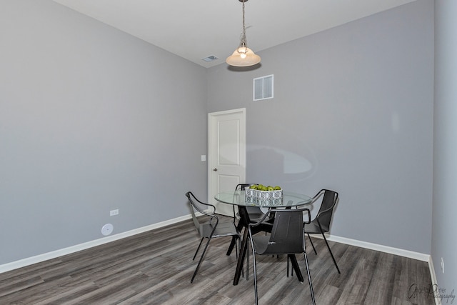 dining room with dark hardwood / wood-style flooring