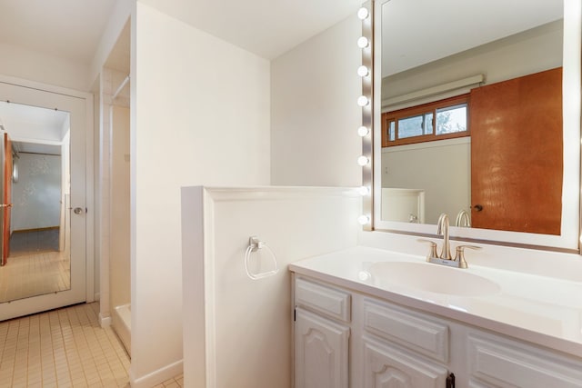 bathroom featuring vanity, tile patterned floors, and walk in shower