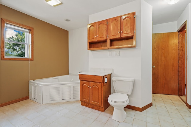 bathroom featuring a tub to relax in, vanity, toilet, and tile patterned flooring