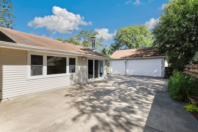 exterior space with an outbuilding and a garage