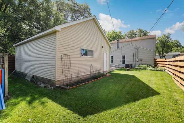 exterior space featuring a lawn and central air condition unit