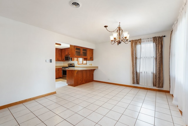 kitchen featuring pendant lighting, a notable chandelier, stainless steel appliances, light tile patterned floors, and kitchen peninsula