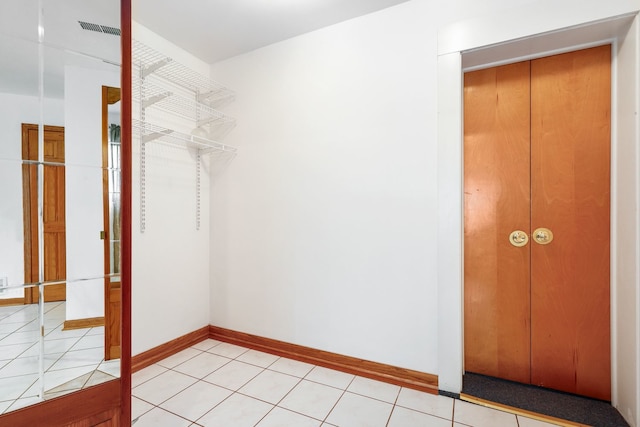 interior space featuring light tile patterned floors and a closet