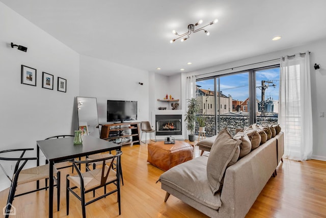 living room featuring light hardwood / wood-style floors and an inviting chandelier