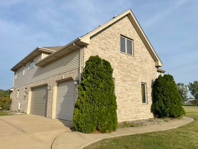 view of property exterior with a garage and a lawn