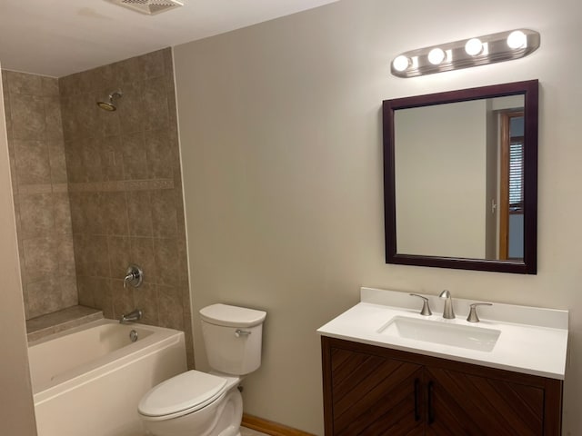 full bathroom featuring tiled shower / bath, toilet, and vanity