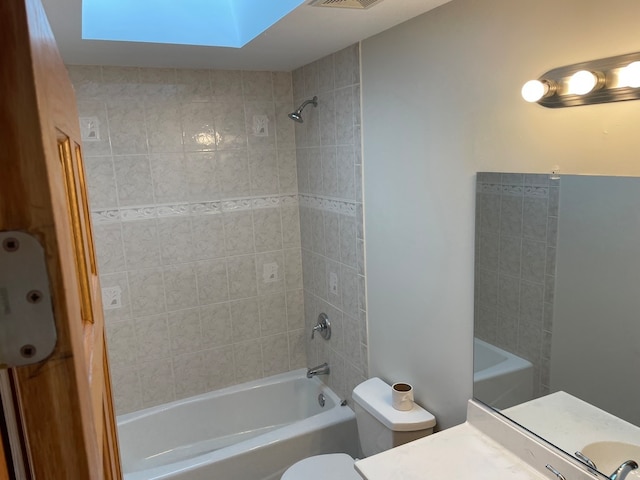 full bathroom with tiled shower / bath, toilet, and vanity