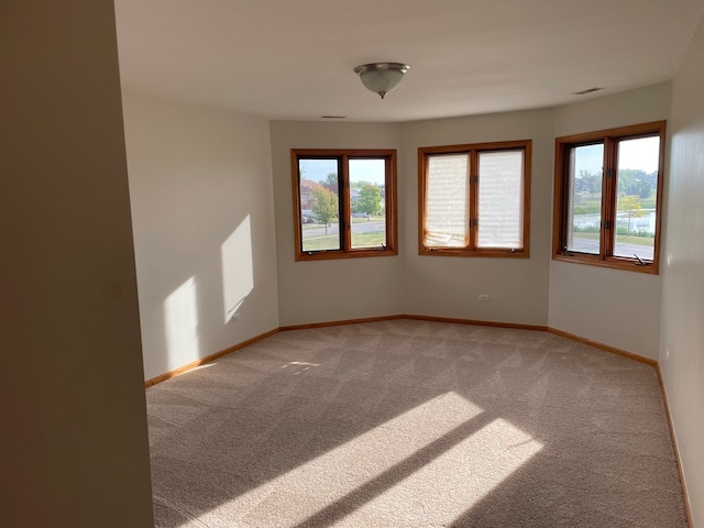 unfurnished room featuring light colored carpet