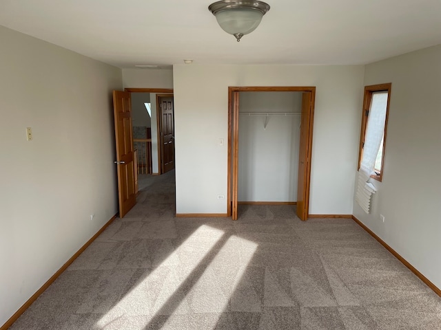 unfurnished bedroom with carpet and a closet