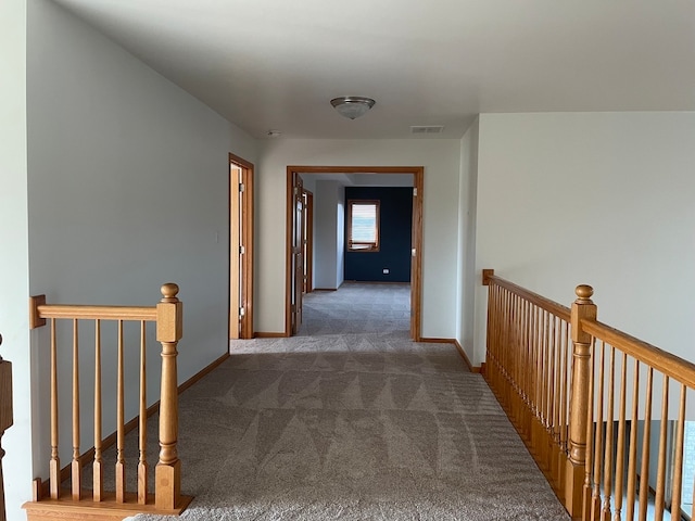 corridor with dark colored carpet