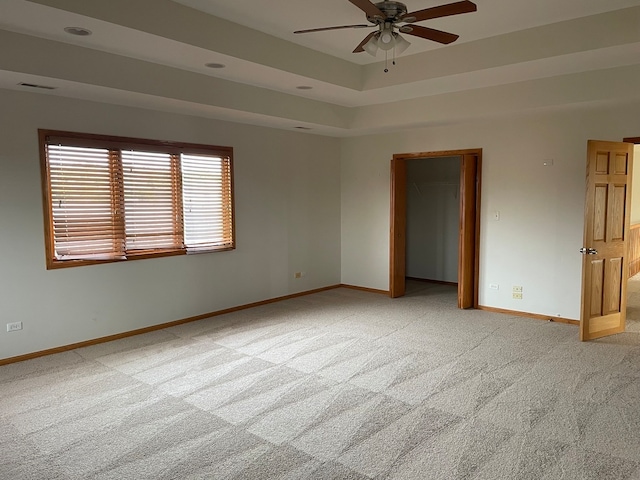 empty room with light colored carpet and ceiling fan