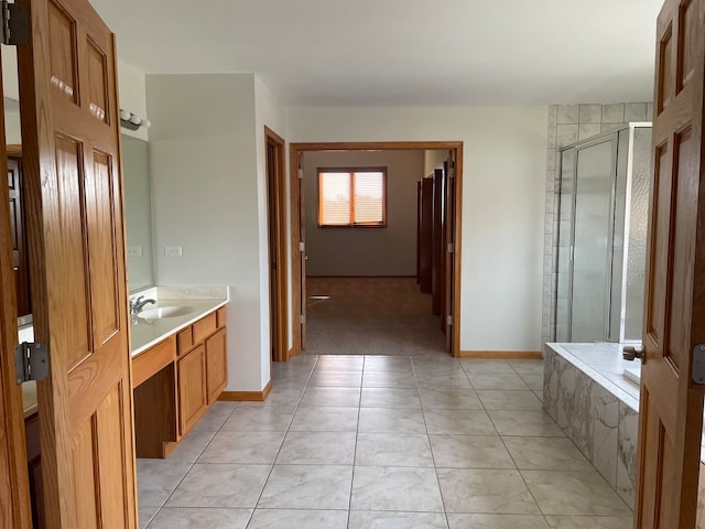 bathroom with plus walk in shower, tile patterned floors, and vanity