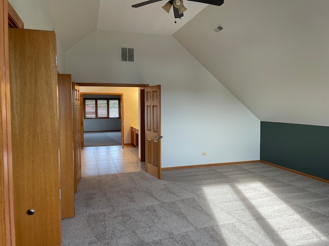 additional living space with high vaulted ceiling, ceiling fan, and light colored carpet