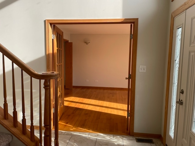 foyer entrance featuring plenty of natural light and light hardwood / wood-style flooring