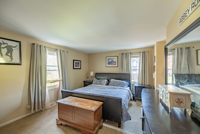 carpeted bedroom featuring multiple windows