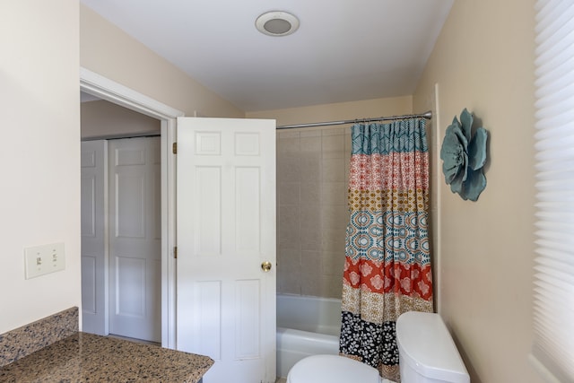 full bathroom featuring shower / bath combo, vanity, and toilet