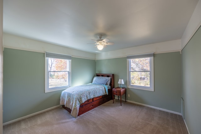 carpeted bedroom featuring ceiling fan, a closet, and multiple windows