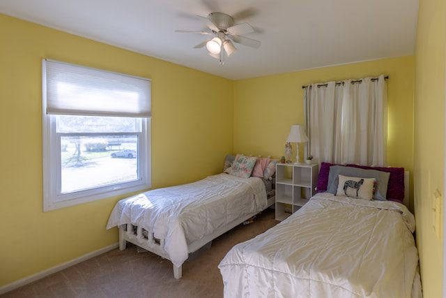 bedroom featuring ceiling fan and carpet