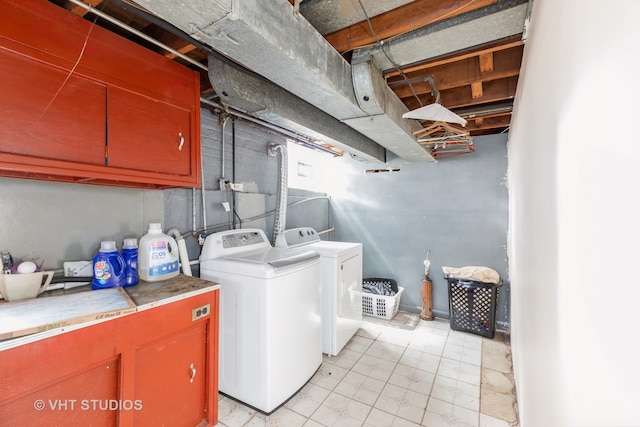 washroom with cabinets and independent washer and dryer