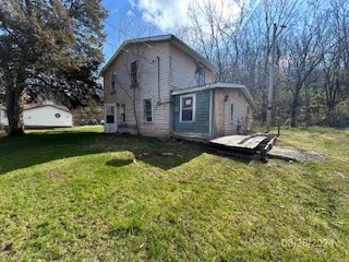 rear view of house with a lawn