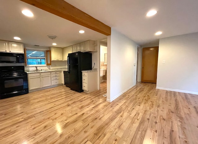 kitchen featuring light wood-type flooring, black appliances, white cabinetry, and sink