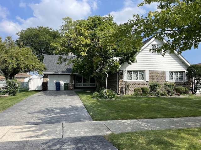 view of front of home with a garage and a front lawn