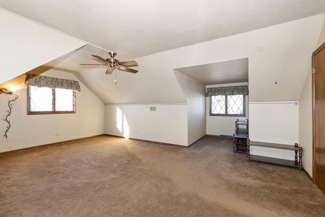 additional living space with ceiling fan, lofted ceiling, and carpet flooring