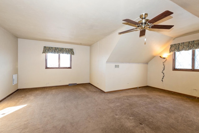 bonus room with vaulted ceiling, carpet floors, and ceiling fan