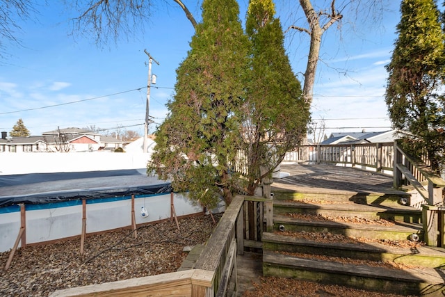 view of yard with a swimming pool side deck