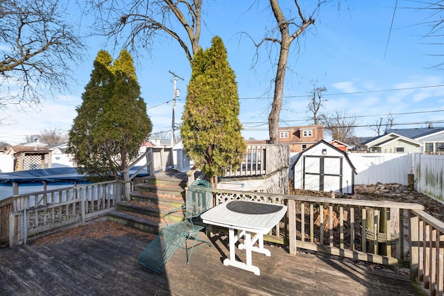 wooden terrace featuring a storage unit