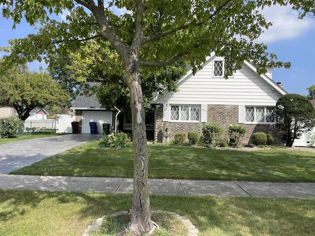 view of front of home with a garage and a front yard