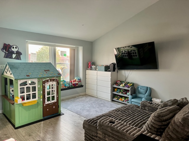 bedroom with vaulted ceiling and light hardwood / wood-style flooring